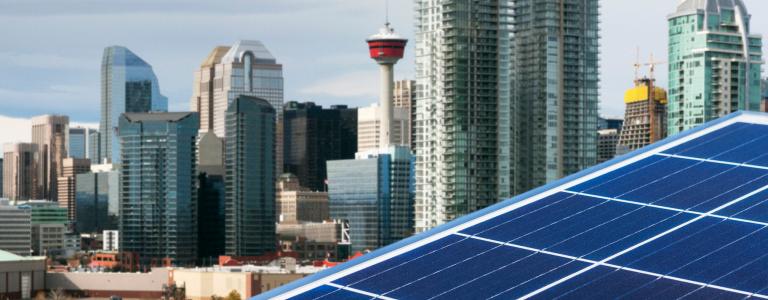 A solar panel in front of the Calgary city skyline.