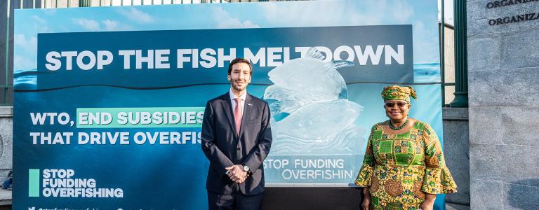 WTO Director-General Ngozi Okonjo-Iweala and Colombian Ambassador to the WTO Santiago Wills at the Stop Funding Overfishing display outside the World Trade Organization headquarters in 2021.