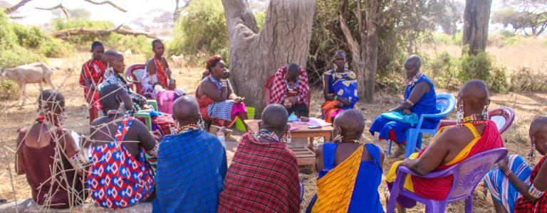 Kenyan women sitting in circle discussing