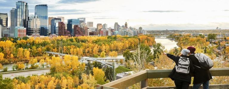 Two people standing in Calgary, Alberta overlooking the river