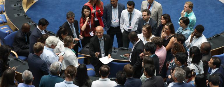 Delegates huddle during the contact group on the Global Stocktake