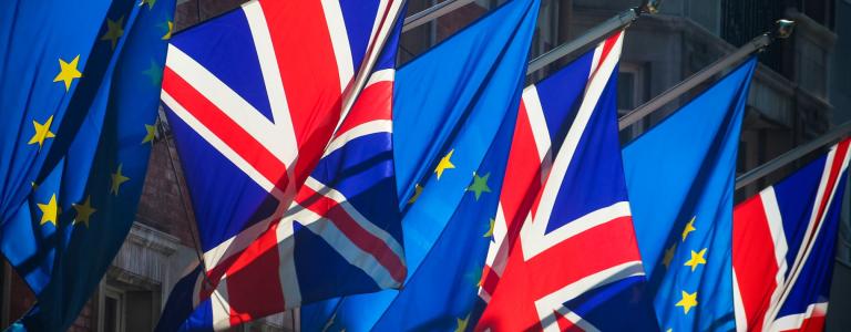Display of EU and UK flags on a building.