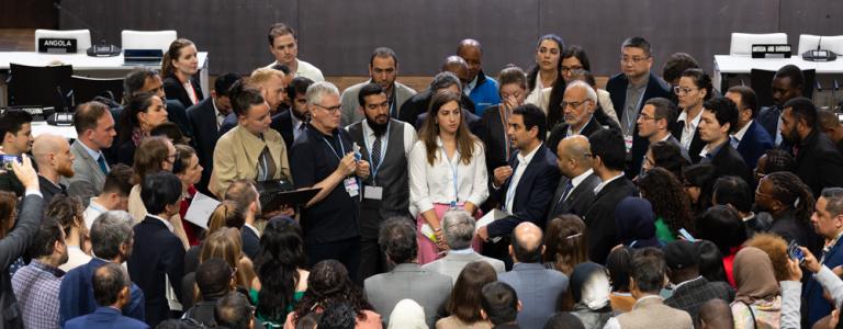 As the June Climate Conference enters its final days, delegates huddle during informal consultations on the Just Transition Work Programme