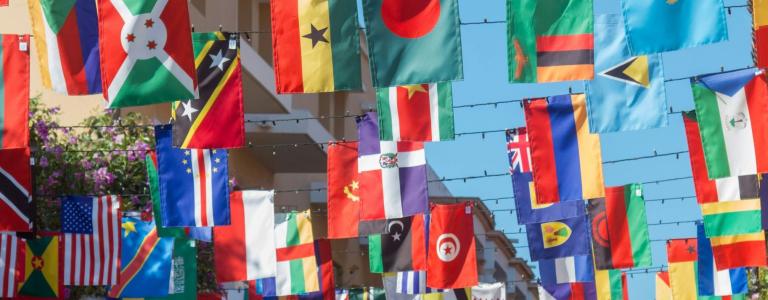 Interntaional flags hang above a street