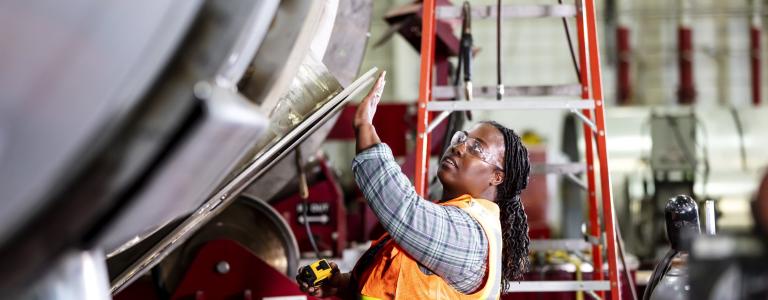 frican-American woman working in metal factory