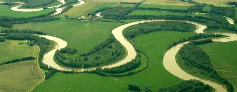 An aerial view of a river on a prairie landscape