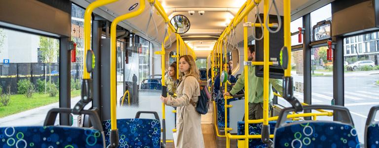Woman standing in bus.
