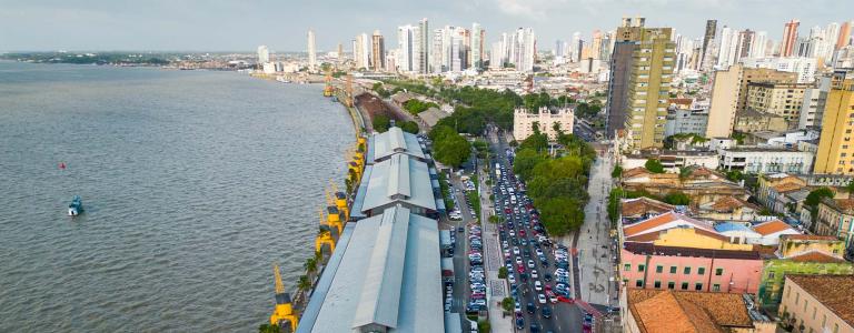Aerial view as traffic crawls along the coastline through the city of Belém.