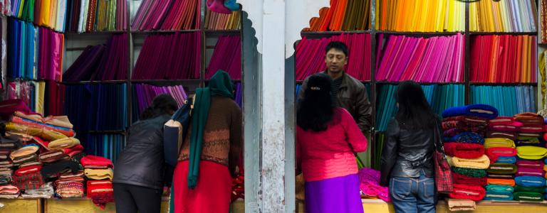A vendor sells colourful fabrics and textiles in Nepal.