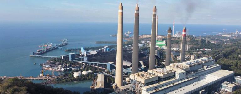 View of coal plant with emissions rising from the stacks