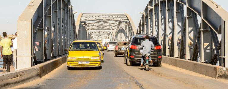 Cars and motorcycles driving on a bridge
