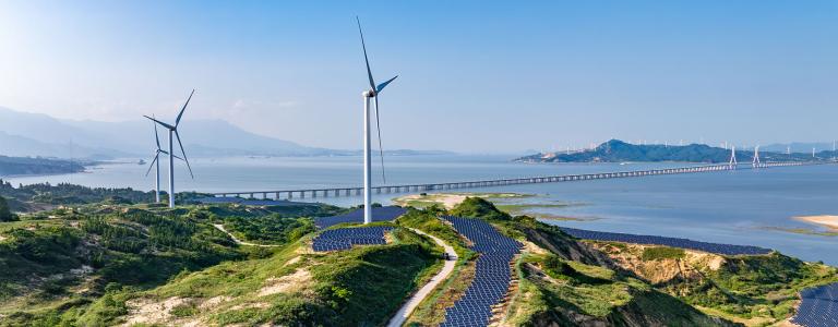 Solar panels and wind turbines dot the landscape in the Chinese countryside countryside.