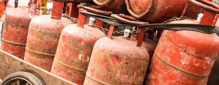 LPG cylinders stacked on a rickshaw cart