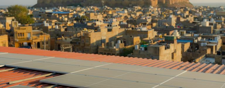Rooftop view of solar panels overlooking city