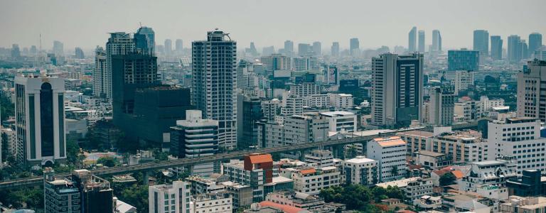 High-rise buildings in dense urban skyline in Bangkok, Thailand. 