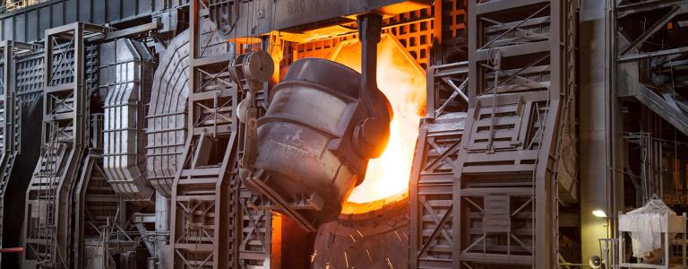 Molten metal being poured at a steel production facility.