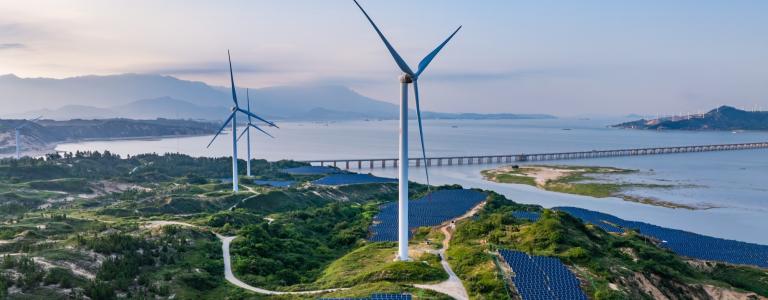 Solar photovoltaic windmill wind energy at sunset 