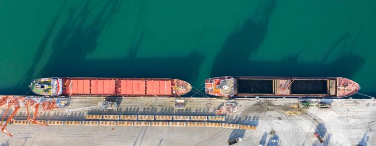 Drone Point View of Cargo Ship in the Port. Aerial view of Coal Ship in a port.
