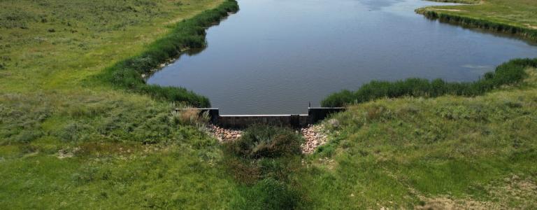 Small dam at a water retention site in Two Hills County, AB