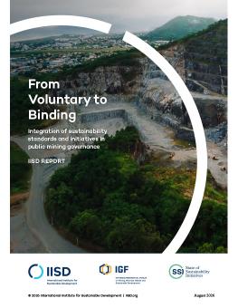 From Voluntary to Binding report cover showing a mine site with a large community in the background.