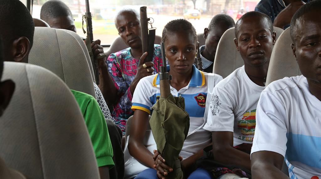 Mobilizing young people to take up farming instead of weapons is a key objective for both adaptation and peacebuilding, as seen here with ex-combatants on their way to farm in a project organized by a UN pilot project on disarmament, demobilization, rehabilitation, and reintegration. 