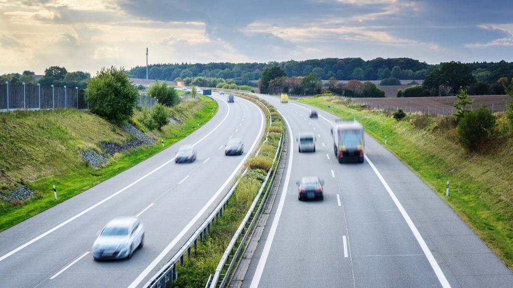 cars drive along a highway