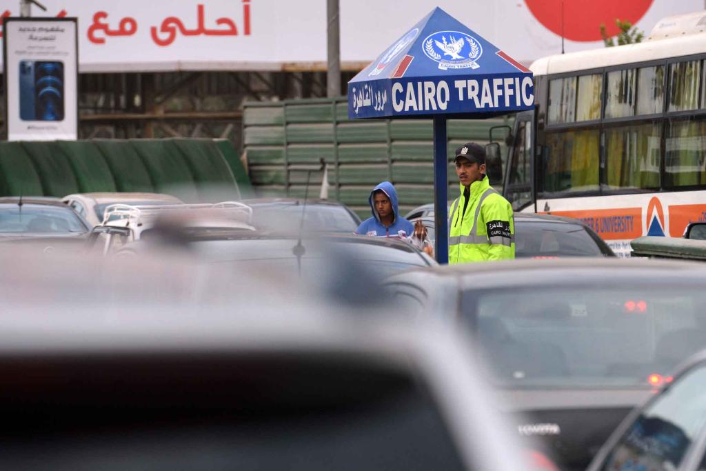 A policeman watches traffic in Cairo, Egypt
