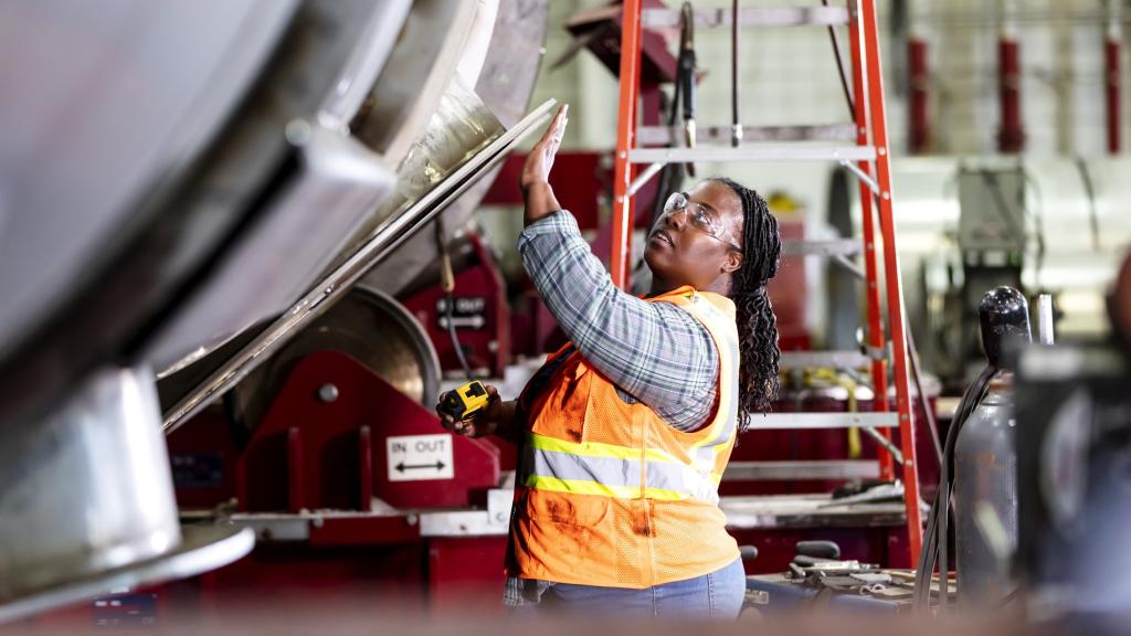 frican-American woman working in metal factory