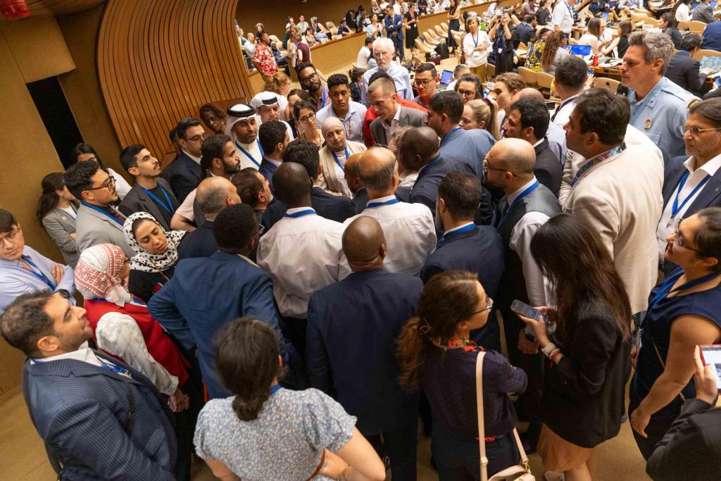 Delegates huddle as they try to progress the text in Contact Group 2 at INC-5.2 plastics treaty talks in Geneva