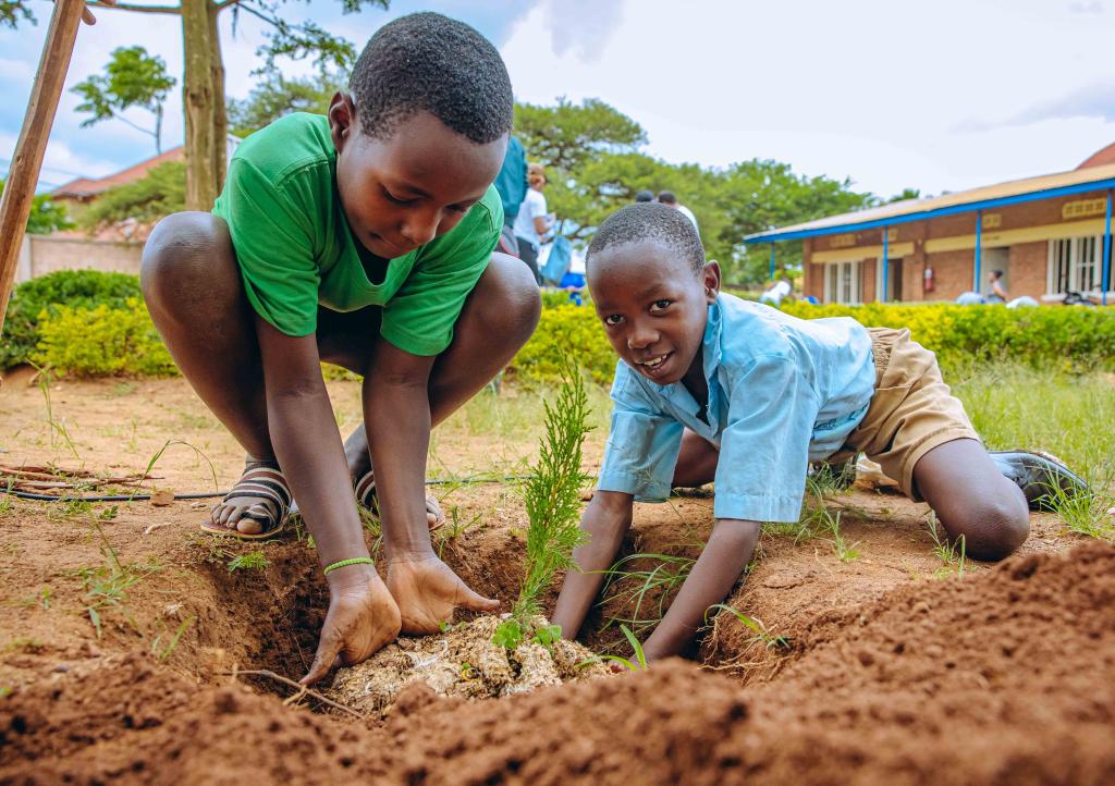 SUNCASA | Kids receive training on trees maintenance at a school in Kigali.