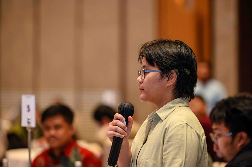 Audience member speaks into a microphone