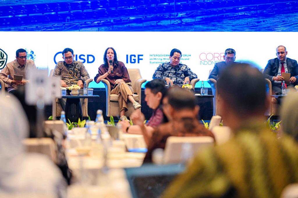 Five panellists sit on stage at a national dialogue in Jakarta