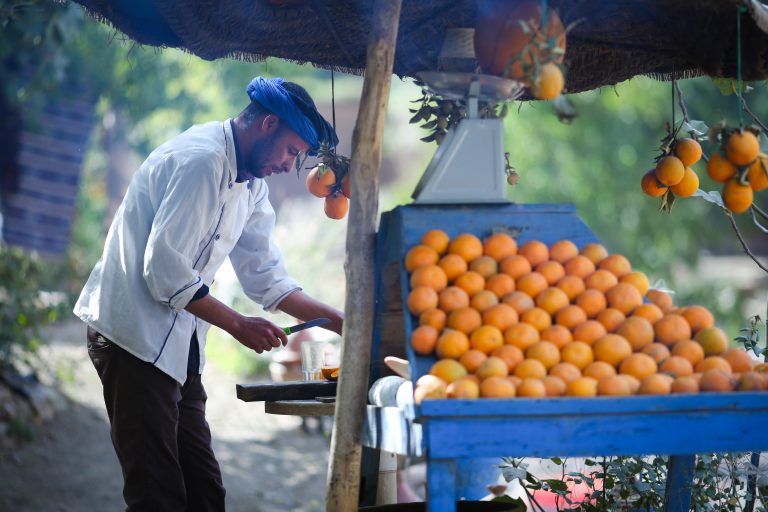 Man in Souss Massa in central Morocco cutting fruit