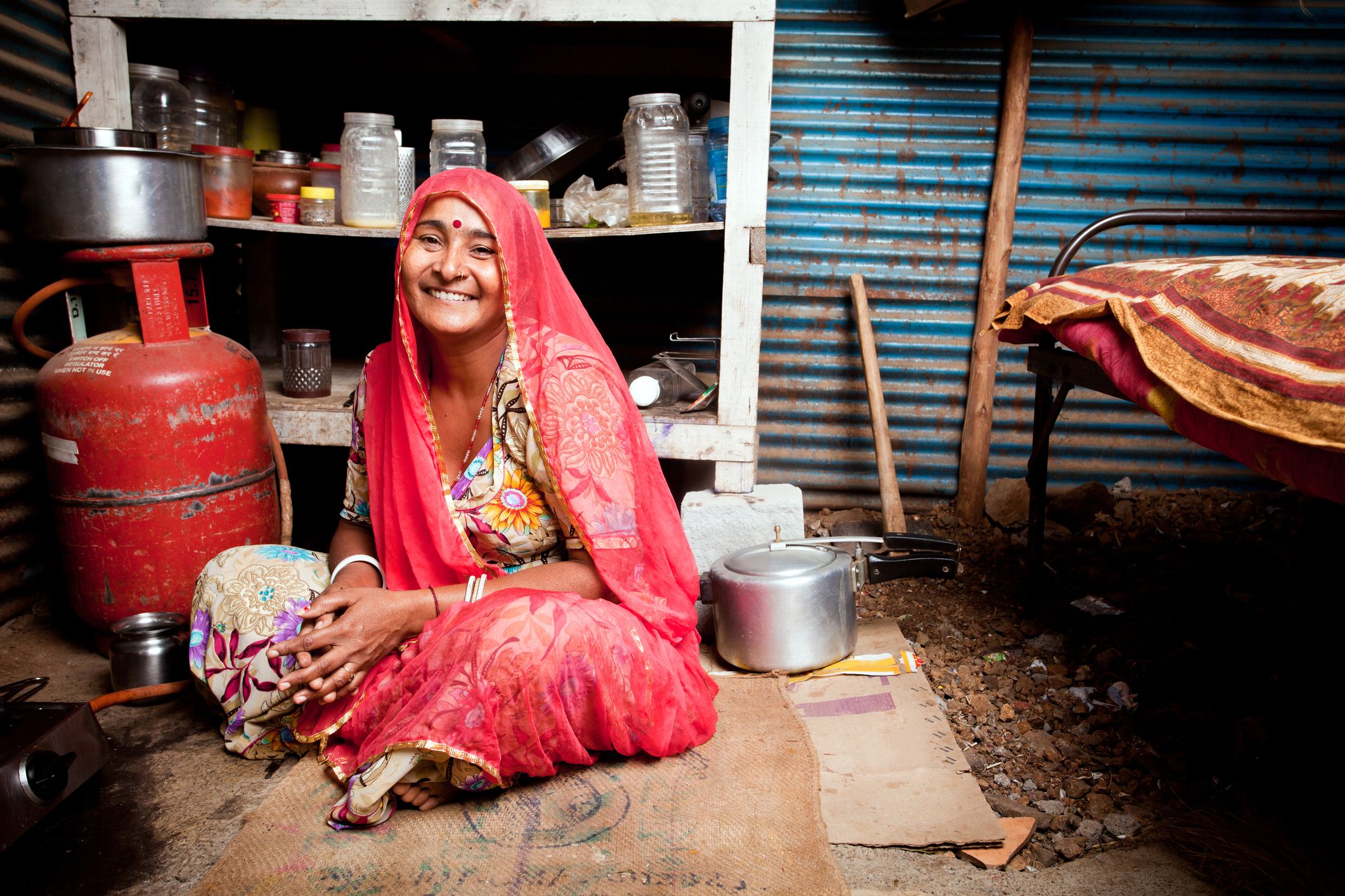 Woman smiling next to cooking stove